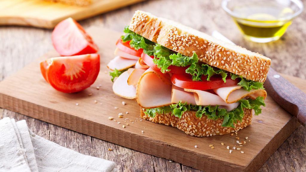 Smoked Turkey Sandwich · Fresh smoked turkey with lettuce, tomatoes, and cheese on your choice of bread.