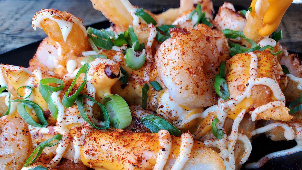 Garlic Shrimp Loaded Fries · Sauteed garlic shrimp, cheddar sauce, mayonnaise, scallions, and cajun seasoning.