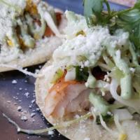 Fish Tacos · Grilled tilapia, jalapeno salsa, yuzu cabbage and grilled corn slaw, cilantro crema, cojita ...