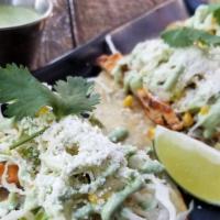 Chicken Tacos · Grilled chicken breast, jalapeno salsa, yuzu cabbage and grilled corn slaw, cilantro crema a...