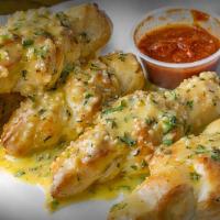 Garlic Bread With Cheese · French garlic bread with cheese served with marinara sauce.