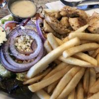 Greek Salad · feta cheese, stuffed grape leaves, tomatoes, red onions and kalamata olives on a bed of mixe...