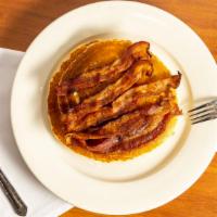 Pancakes Deluxe · Served with ham, bacon, sausage and butter and syrup.