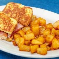 Monte Cristo Sandwich With French Fries · Thick slices of challah bread, grilled Swiss cheese with ham and white meat turkey. Served w...