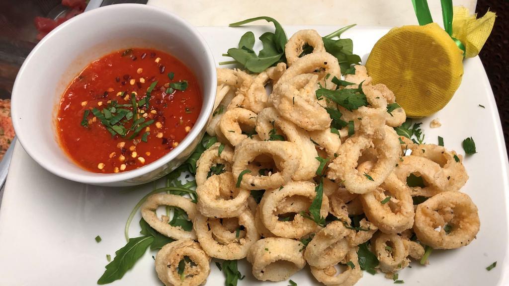 Calamari · Crispy calamari, lightly coated with rice flour, side of spicy tomato sauce.  Gluten free.