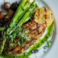 Chicken Under A Brick · Grilled and crispy - all-natural Frenched chicken breast, lemon-herb butter (packed on the s...