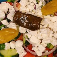 Greek Salad · Romaine Lettuce, Tomato, Cucumber, Onions, Feta, Olives, Olive Oil Dressing.