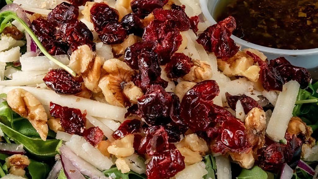 Arugula Salad · Arugula, Walnuts, Cranberries,  Graviera Cheese, Red Onions, Balsamic Vinaigrette.