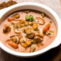 Mutter Mushrooms · Fresh mushrooms simmered in a rich, tomato-based curry with peas and aromatic spices and her...