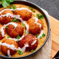 Malai Kofta · Fresh grated vegetables cooked gravy, flour batter and deep fried, served in a tomato and on...