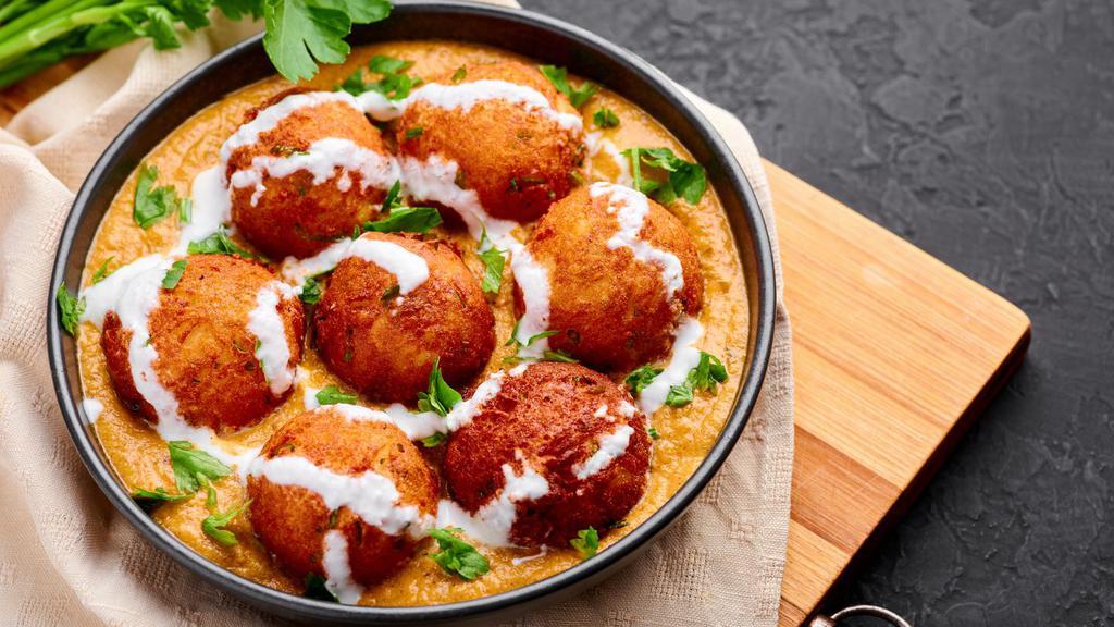 Malai Kofta · Fresh grated vegetables cooked gravy, flour batter and deep fried, served in a tomato and onion sauce.