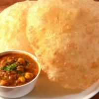 Punjabi Chole Bhature & Poori · Tender chickpeas simmered in a tangy, spiced gravy and served with puffy, deep-fried breads.