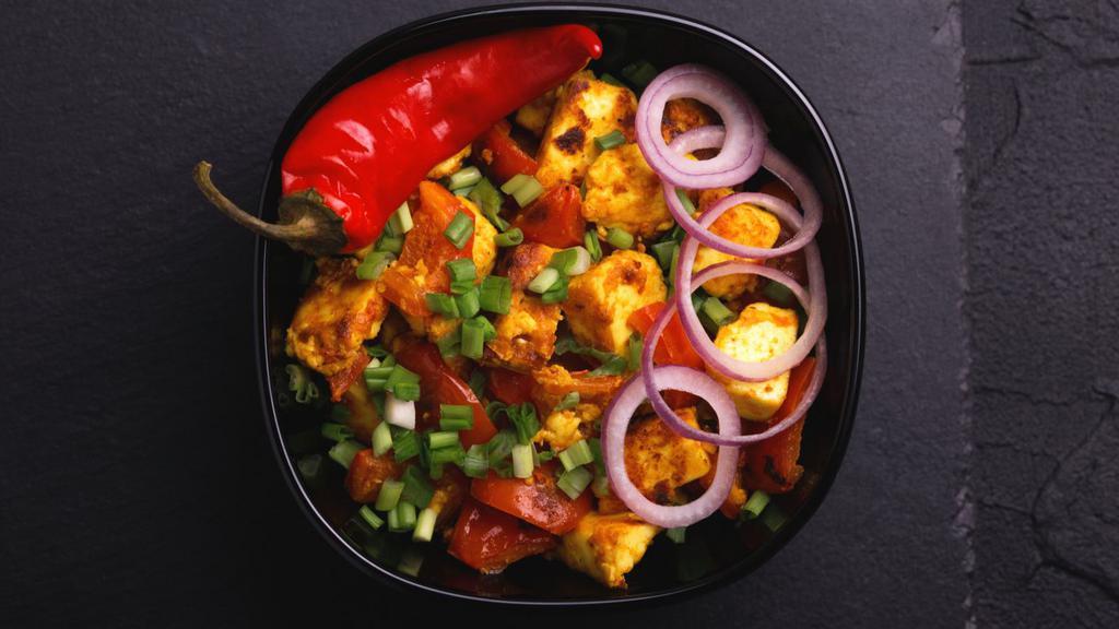 Chili Paneer · Our house-made, paneer cheese cubes marinated in soy sauce, chili sauce and pepper and deep-fried until crispy and tossed in a sweet, spicy and tangy dry sauce made with soy sauce, chilies and other spices.