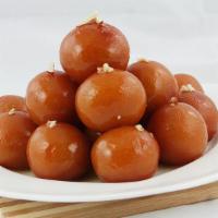 Gulab Jamun · Delicately fried milk dumplings soaked in cardamom flavored syrup.