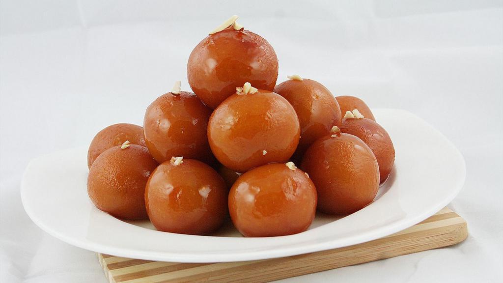 Gulab Jamun · Delicately fried milk dumplings soaked in cardamom flavored syrup.