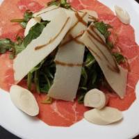 Carpaccio Di Manzo · Thinly sliced beef, arugula, shaved parmesan, heart of palm.