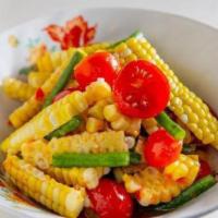 Corn Salad To Go · Vegan. Steamed corn, cherry tomato, long beans, garlic, lime, Thai bird's eye chili. Moderat...