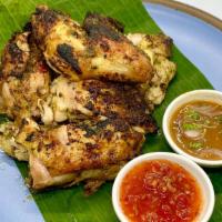 Isan Chicken To Go · Half chicken marinated with Thai herbs  served with Jaew sauce and Sweet chili sauce