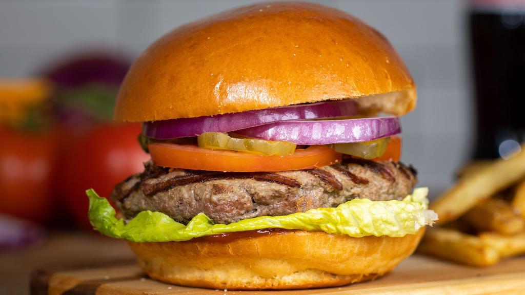 American Burger · American beef patty, lettuce, tomato, onion, and mayo on a warm classic bun.