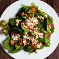 Spinach Me Up Salad · Fresh feta cheese, almonds, tomatoes, raspberry vinaigrette in a bed of baby spinach.