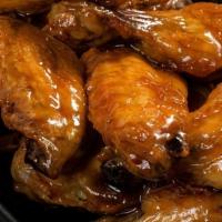 Honey Garlic Wings · Traditional bone-in wings,Hand-tossed in your choice of
sauce or rub. Choose your
flavors!