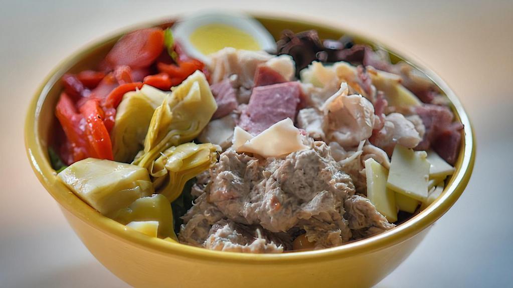 Antipasto · Roasted red peppers, tuna, salami, provolone cheese, slow-roasted turkey, Kalamata olives, artichoke hearts and egg. Made with a crispy blend of romaine and iceberg.