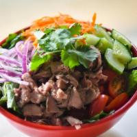 Thai Beef · Thinly sliced sirloin, red onion, cucumber, tomato, carrot and cilantro. Made with a crispy ...