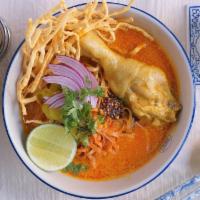 Chicken Khao Soi · Northern-style curry soup served with egg noodles along with a tender chicken leg, shallots,...
