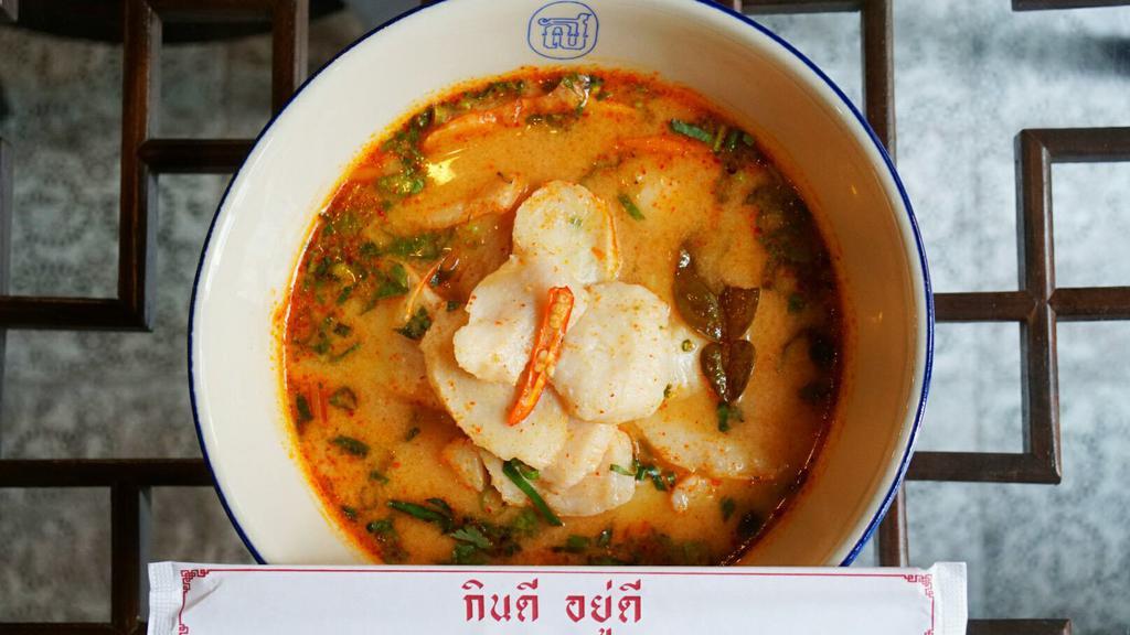 Seafoood  Noodle Soup · Spicy creamy and savory tom yum fish served with rice noodles, homemade fish cakes, shrimp and squids. Topped with culantro in fresh fragrant herbal broth.