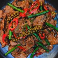 Prik Khing Moo Noom · Stir fried pork in chili and herb paste, long bean, pepper, young pepper corn and kaffir lim...