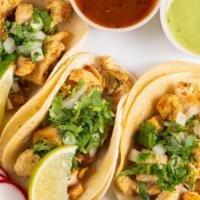 Chicken Taco (3 Pcs) · Tacos topped with fresh onions and cilantro, garnish with a lime wedge and radish, accompani...