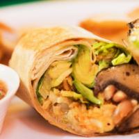 Mushrooms And Avocado Burrito · Mexican rice, pinto beans, lettuce, Monterrey Jack cheese, sour cream, and our homemade sals...