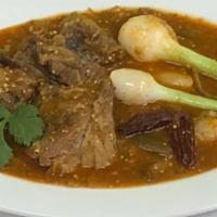 Entomatado De Res · Beef stew with tomatillo and chipotle thick sauce.