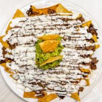 Bistec Nacho · Steak. Served with black beans, sour cream, cheese and guacamole.