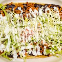 Cecina Huarache · Salted beef. Served with black beans, lettuce, onion, cheese and cream.