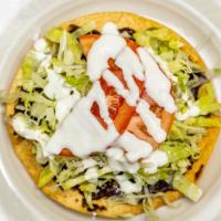 Bisteck Tostada · Steak. Served with black beans, tomato, lettuce, cheese and sour cream.