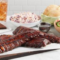 Baby Back Ribs · Slow-roasted and grilled pork ribs glazed in BBQ sauce. Served with your choice of a salad a...