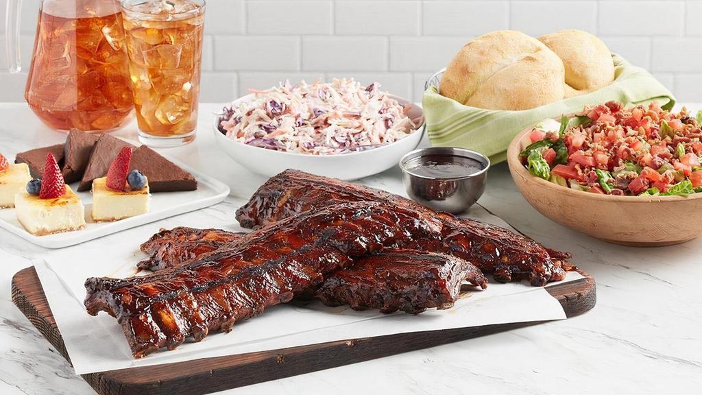 Baby Back Ribs · Slow-roasted and grilled pork ribs glazed in BBQ sauce. Served with your choice of a salad and side. Comes with dessert. Serves 4-6. No substitutions, please.