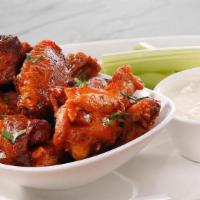 Smoked Chicken Wings · Buffalo hot sauce, celery; Chef recommends bleu cheese or roasted garlic ranch dressing