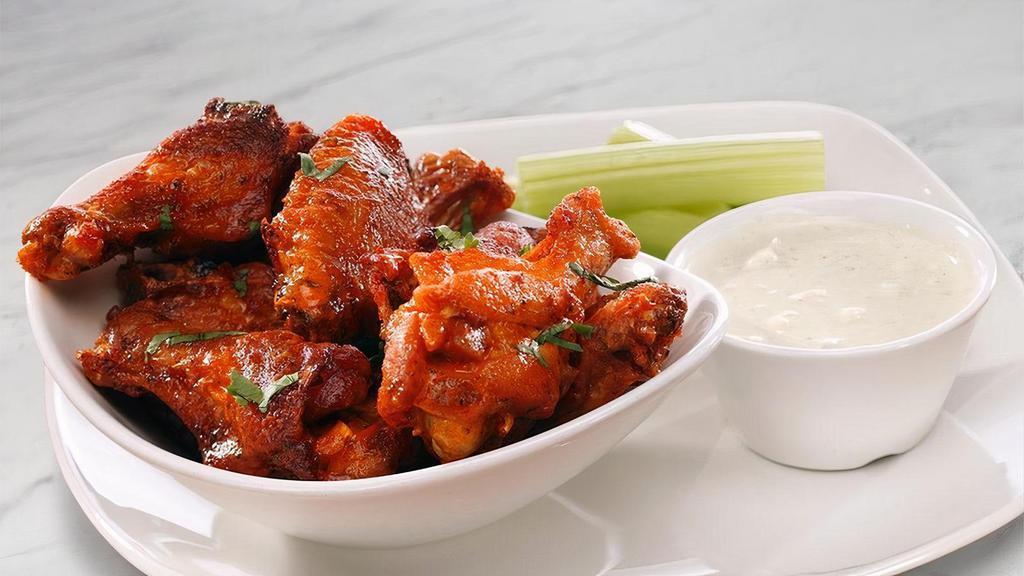 Smoked Chicken Wings · Buffalo hot sauce, celery; Chef recommends bleu cheese or roasted garlic ranch dressing