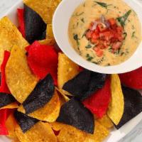 Lobster Spinach Queso · Lobster, baby spinach, tomatoes, pepper jack cheese, tortilla chips