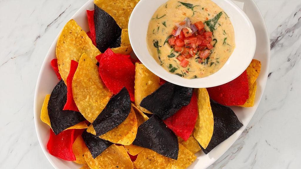 Lobster Spinach Queso · Lobster, baby spinach, tomatoes, pepper jack cheese, tortilla chips