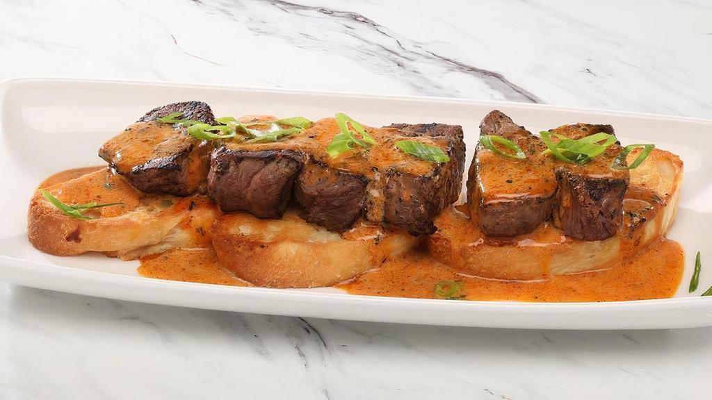 Tenderloin Medallions · with New Orleans BBQ Butter Sauce served over toasted focaccia