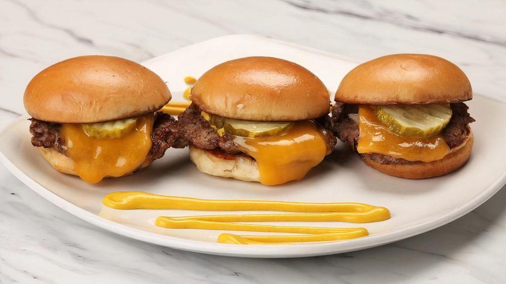 Beef Sliders* · Three USDA Choice mini burgers with Tillamook cheddar cheese, sauteed onions, yellow mustard and pickles.