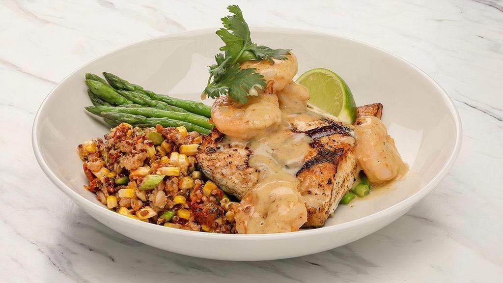 Striped Bass · Wood grilled striped bass topped with large shrimp in a Key lime butter sauce, served with ancient grains pilaf and asparagus