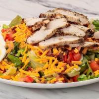 Grilled Chopped Cobb Salad · Wood grilled chicken, romaine and iceberg lettuce tossed with tomatoes, sliced egg, smoked c...