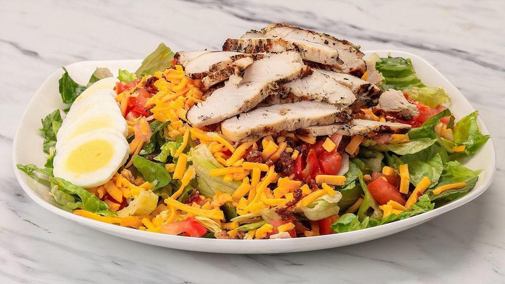 Grilled Chopped Cobb Salad · Wood grilled chicken, romaine and iceberg lettuce tossed with tomatoes, sliced egg, smoked cheddar, applewood-smoked bacon; Chef recommends roasted garlic ranch dressing
