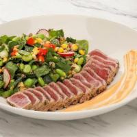 Seared Tuna Superfoods Salad · Seared and sliced sushi-grade tuna served over a bed of spinach, organic ancient grains, cuc...
