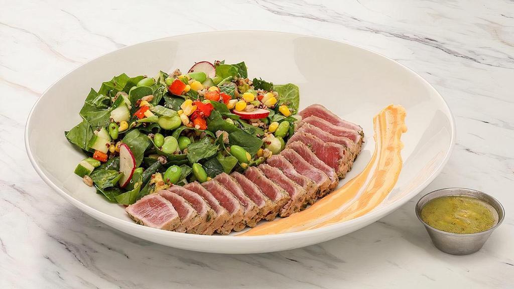 Seared Tuna Superfoods Salad · Seared and sliced sushi-grade tuna served over a bed of spinach, organic ancient grains, cucumbers, avocado, grilled corn, edamame, radish; Chef recommends avocado lime vinaigrette