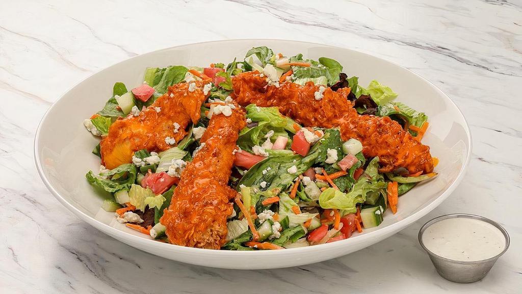 Buffalo Chicken Salad · Mixed greens with carrots, cucumbers, tomatoes and bleu cheese crumbles, topped with hand-breaded chicken tenders tossed in our house-made buffalo sauce; Chef recommends bleu cheese dressing (dressing served on the side)